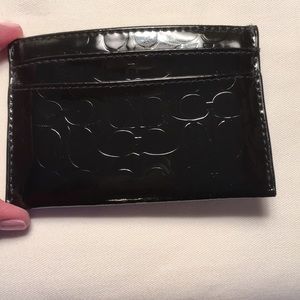 Embossed Coach card case. 3 slots w center storage